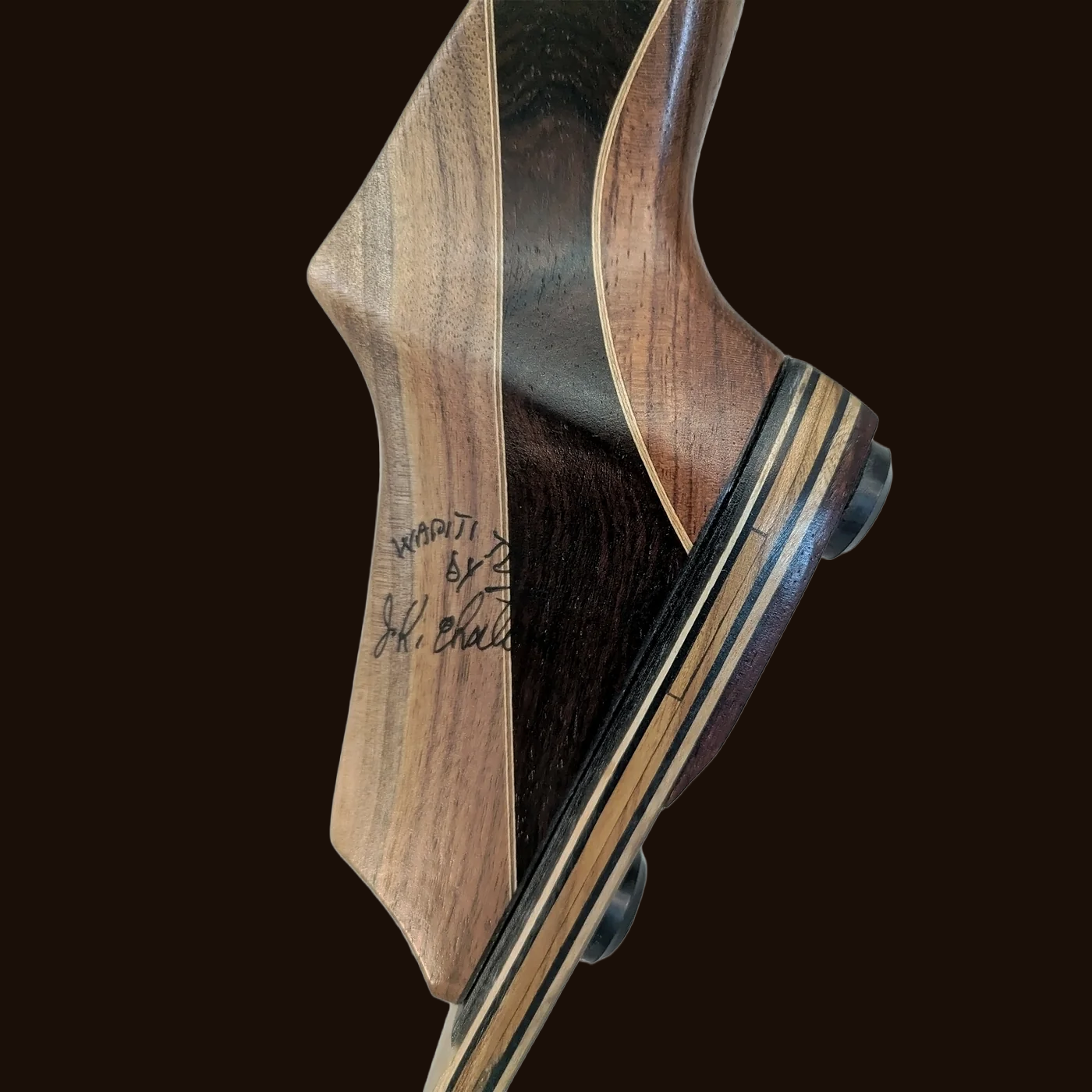 Hand-signed Wapiti riser showing figured wood grain